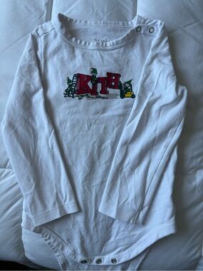 Kith White Long-Sleeve Baby Onesis with Red Logo and Green Accent